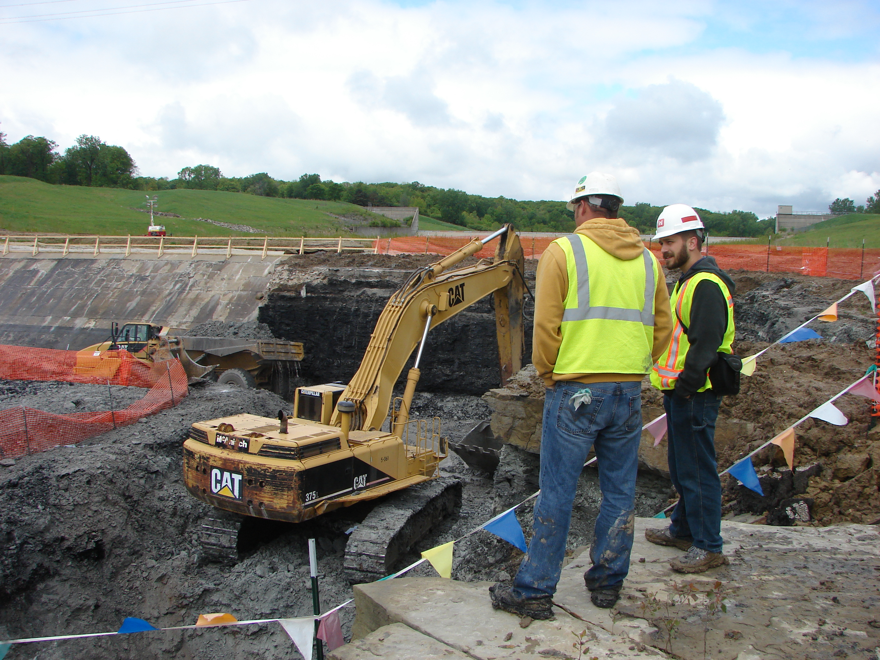 An engineer with the Corps of Engineers talks with a contractor at a construction site at Saylorville Lake.