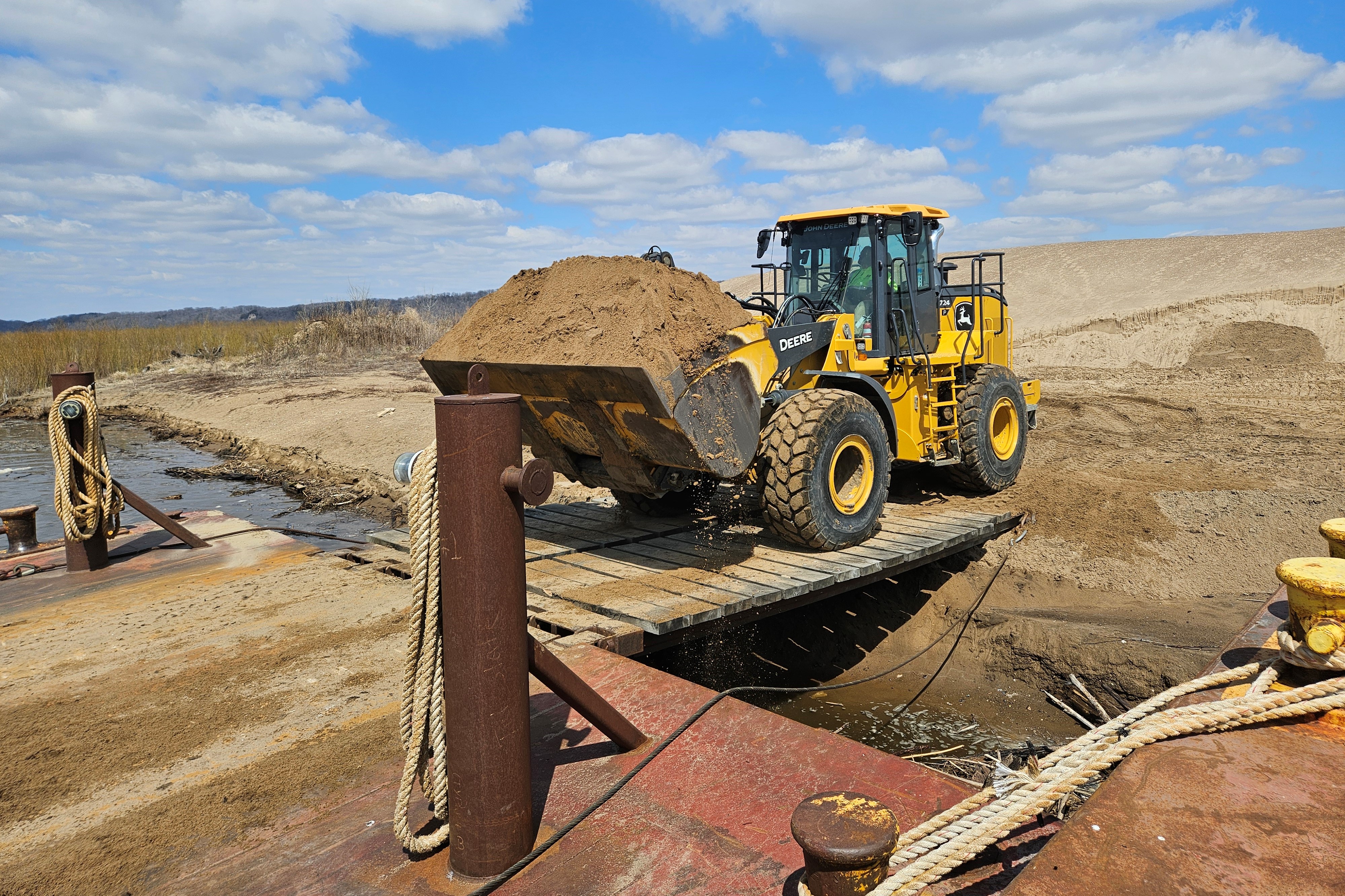 Dredge material being transported by a loader. 